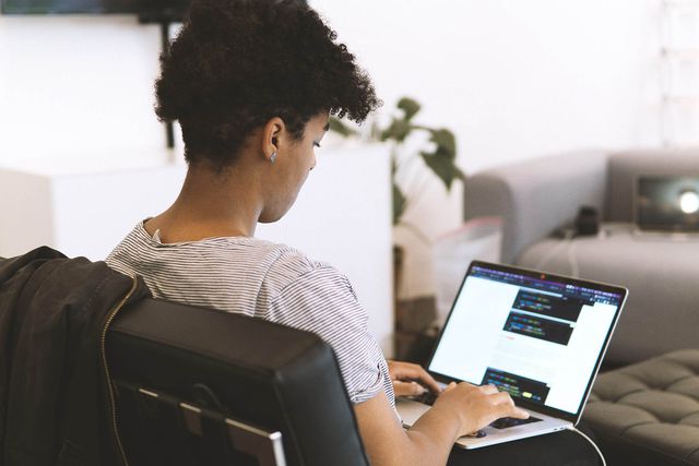 Woman reading code documentation at her laptop